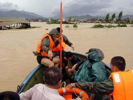 Soldiers of the local frontier defence troop rescue trapped residents in Zhao'an County, southeast China's Fujian Province, June 22, 2009. Affected by tropical storm Linfa, the third this year, heavy rainstorm hit Zhao'an county on Sunday night. Over 100 residents trapped by floods have all been transferred to safe areas by Monday afternoon. (Xinhua/Xu Guoqing)