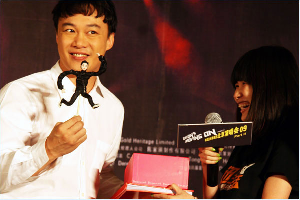 Hong Kong pop singer Eason Chan (Left) holds a hand-made doll of himself given to him by a female fan at a Beijing Concert press conference on Monday, June 22nd, 2009.