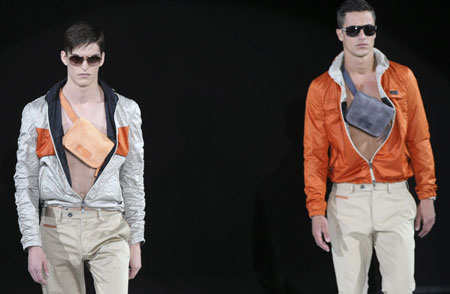 Two models present creations as part of Emporio Armani Spring/Summer 2010 men's collection during Milan Fashion Week June 23, 2009.