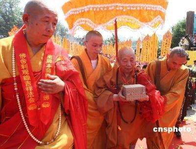 Monks and Buddhists welcome two relics said to be from body of Sakyamuni, founder of Buddhism at Beijing Yunju Temple on Tuesday, June 23, 2009. The relics were returned to the temple from the Capital Museum.