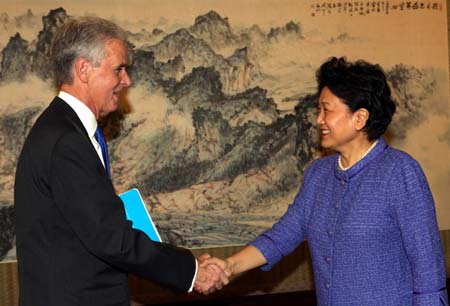 Chinese State Councilor Liu Yandong (R) shakes hands with Gaston Caperton, president of the U.S. College Board, during their meeting in Beijing, capital of China, on June 25, 2009. Gaston Caperton led a delegation of 430 schoolmasters from 40 states to attend a Chinese language proficiency competition in Beijing. 