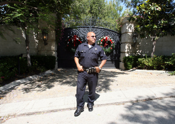 Police gather outside Michael Jackson's house in Los Angeles, CA after hearing he had been rushed to hospital.