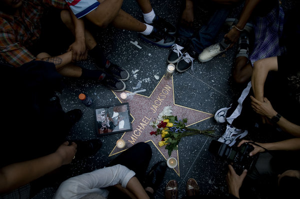 Fans of pop star Michael Jackson sit vigil by his Star on the Hollywood Walk of Fame mourning his death on June 25, 2009 in Los Angeles, California.