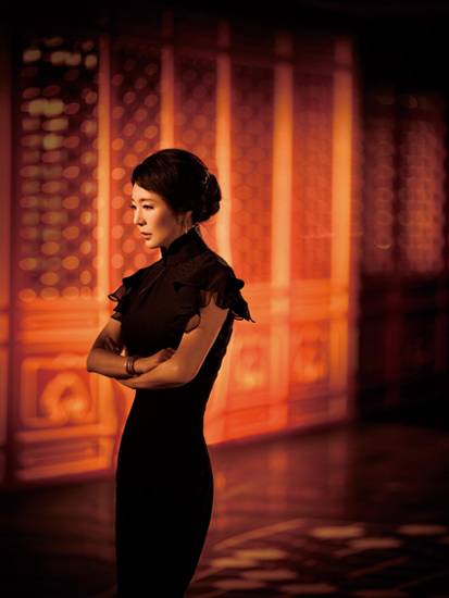 Chinese novelist Yan Geling poses in classic Chinese-styled long gown.