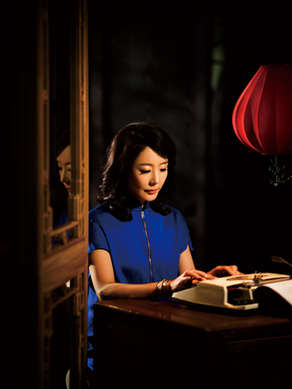 Chinese novelist Yan Geling poses in classic Chinese-styled long gown.