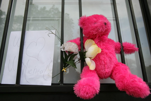 A pink teddy bear is displayed with a flower outside the former childhood home of Pop Star Michael Jackson on June 25, 2009 in Gary, Indiana. 