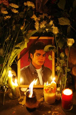 Candles are placed in front of the portrait of pop star Michael Jackson at the U.S. embassy in Moscow, June 26, 2009.