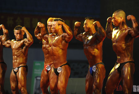 A group of men contestants show up their muscles during the 2009 National Bodybuilding & Fitness Championship, concurrently the Preliminary Contest of Fitness to the 4th National Sports Assembly, in Hefei, east China&apos;s Anhui Province, June 27, 2009. Some 200 contestants from 26 delegations across the country take part in the competition in a total of 6 categories. (Xinhua/Shen Xiang)