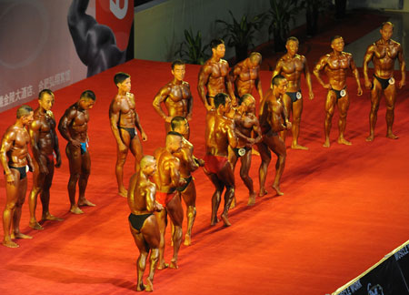 A group of men contestants show their muscles collectively during the 2009 National Bodybuilding and Fitness Championship, concurrently the Preliminary Contest of Fitness to the 4th National Sports Assembly, in Hefei, east China's Anhui Province, June 27, 2009. Some 200 contestants from 26 delegations across the country take part in the competition in a total of 6 categories.