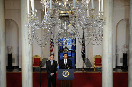 U.S. President Barack Obama (R) delivers remarks to urge the U.S. Senate to pass his clean energy bill, as U.S. Department of Energy Secretary Steven Chu stands by, in the Grand Foyer of the White House in Washington D.C., capital of the United States, June 29,2009. [Zhang Yan/Xinhua]