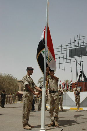 Iraqi honor guard raise the country's national flag during a hand-over ceremony from the U.S. military to Iraq security forces in Baghdad, capital of Iraq, June 29, 2009. June 30 is the deadline for U.S. combat troops to withdraw from major cities in Iraq. (Xinhua)