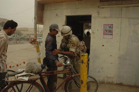 A soldier of Iraqi security forces searches a man at the entrance of a community in Baghdad, capital of Iraq, on June 28, 2009. As part of a security pact signed between Baghdad and Washington last year, U.S. troops will withdraw from Iraq's cities, towns and villages by June 30, 2009 to their bases, and will leave the country by December 31, 2011. (Xinhua/Gao Shan)