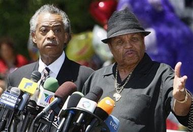 Rev. Al Sharpton and Joe Jackson, Michael Jackson's father, speak at a news conference in front of the the Jackson family residence in Encino, Calif., Monday, June 29, 2009. [Charles Dharapak/CCTV/AP Photo]