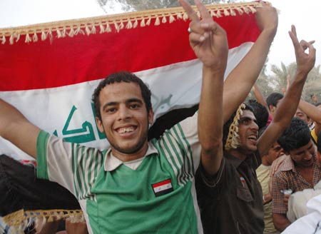 Iraqis celebrate the withdrawal of the U.S. combat troops from Iraqi cities and towns in Baghdad, capital of Iraq, June 29, 2009. As part of a security pact signed between Baghdad and Washington last year, the U.S. troops would withdraw from Iraqi cities, towns and villages by June 30, 2009 to their bases, and would leave the country on Dec. 31, 2011. (Xinhua/Gao Shan)