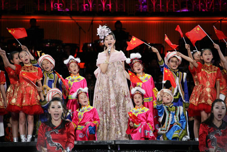 Song Zuying (C), a famous Chinese singer, performs singing at the 'Beijing Bird's Nest Summer Concert' at the National Stadium, or the 'Bird's Nest', in Beijing, June 30, 2009. 