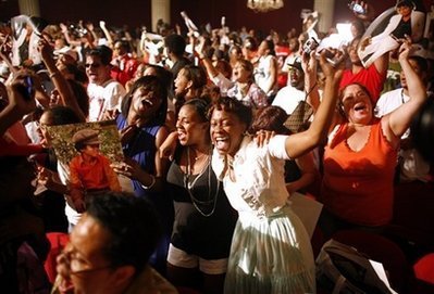Fans sing and dance to the music of Michael Jackson during a tribute to the late singer at Harlem's Apollo theatre Tuesday, June 30, 2009 in New York. Jackson died Thursday in Los Angeles at the age of 50.