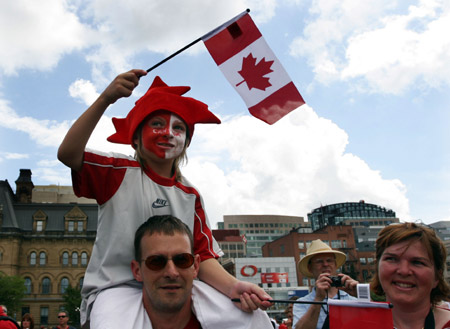 A child waves Canada's flag during Canada Day celebrations on Parliament Hill in Ottawa, capital of Canada, July 1, 2009. Canadians celebrated their country's 142nd birthday on Wednesday. (Xinhua/Zou Zheng)