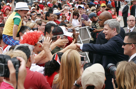 Canada's Prime Minister Stephen Harper shakes hands with spectators during Canada Day celebrations on Parliament Hill in Ottawa, capital of Canada, July 1, 2009. Canadian celebrated their country's 142nd birthday on Wednesday. (Xinhua/Zou Zheng)