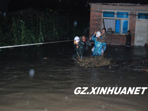 Firefighters help to evacuate residents in Guiding County, southwest China's Guizhou Province June 30, 2009. Nine people were killed and another is missing in disasters resulting from torrential rains since Sunday in this province.