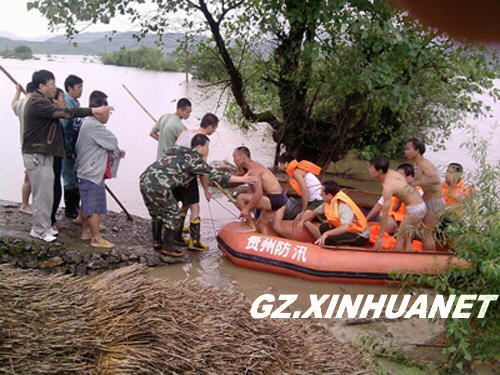 Firefighters help to evacuate residents in Guiding County, southwest China's Guizhou Province June 30, 2009. Nine people were killed and another is missing in disasters resulting from torrential rains since Sunday in this province. 