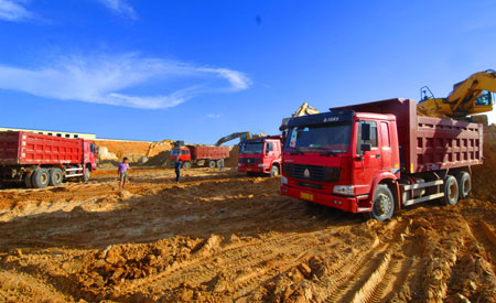 Workers work at the construction site of the Changjiang Nuclear Power Plant, south China's Hainan Province, July 1, 2009. With a total investment of 17 billion yuan, the construction of the first stage of the Changjiang project with two units that generate 650,000 kilowatts each is expected to be started this October and put into practice in 2014. The two units will use advanced second-generation pressurized water reactor technology. [Zhao Yingquan/Xinhua]