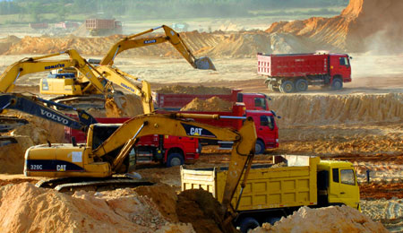 Engineering trucks are seen at the construction site of the Changjiang Nuclear Power Plant, south China's Hainan Province, July 1, 2009. With a total investment of 17 billion yuan, the construction of the first stage of the Changjiang project with two units that generate 650,000 kilowatts each is expected to be started this October and put into practice in 2014. The two units will use advanced second-generation pressurized water reactor technology. [Zhao Yingquan/Xinhua]