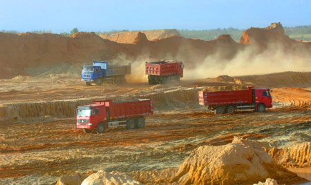 Engineering trucks are seen at the construction site of the Changjiang Nuclear Power Plant, south China's Hainan Province, July 1, 2009. With a total investment of 17 billion yuan, the construction of the first stage of the Changjiang project with two units that generate 650,000 kilowatts each is expected to be started this October and put into operation in 2014. The two units will use advanced second-generation pressurized water reactor technology. [Zhao Yingquan/Xinhua]