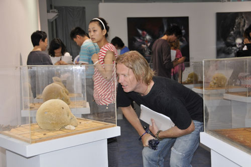 Viewers looking at works in the Chengdu art exhibition 'Beyond the Border'.