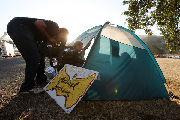 A television news crews interviews a fan trying to sleep in the early morning in a tent along the road outside the gates of Neverland Ranch as fans worldwide continue to mourn the loss of singer Michael Jackson on July 2, 2009 near Los Olivos, California. Jackson, 50, the iconic pop star, died at UCLA Medical Center after going into cardiac arrest at his rented home just minutes away on June 25 in Los Angeles, California. 