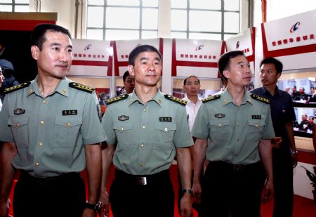 Chinese astronauts (L to R) Zhai Zhigang, Liu Boming and Jing Haipeng attend the exhibition 'Roaming the Universe -- Aerospace Exhibition for China