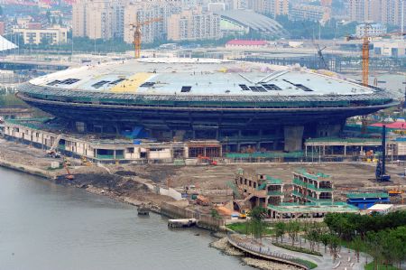 Photo taken on July 4, 2009 shows the Performing Arts Center under construction for the Shanghai 2010 World Expo in Shanghai, east China. The Shanghai 2010 World Expo is to open on May 1, 2010. [Guo Changyao/Xinhua]