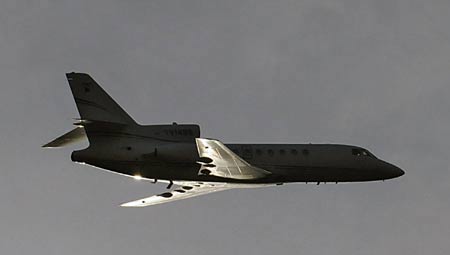 The Venezuelan airplane carrying ousted Honduran President Manuel Zelaya overflies Toncontin international airport in Tegucigalpa. At least half a dozen military vehicles blocked the only runway at the airport preventing Zelaya's landing while tens of thousands of his supporters demonstrated outside. [Xinhua/AFP]