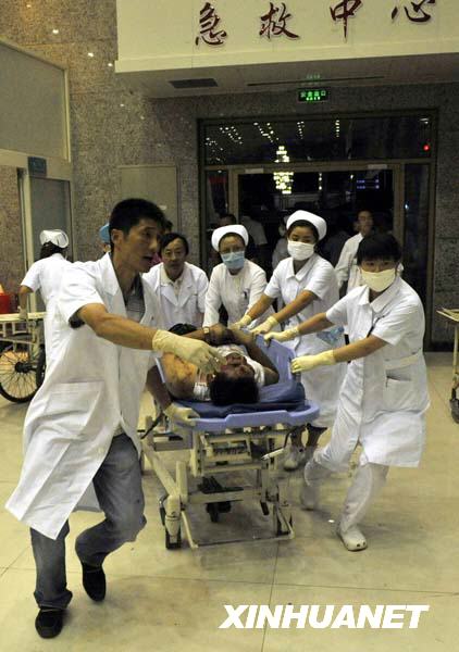 An injured man is carried to an urgent care center in Urumqi, capital of northwest China's Xinjiang Uygur Autonomous Region on July 5, 2009. 