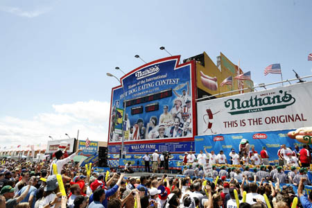 Joey Chestnut reacts after winning the Nathan's annual hot dog eating contest in the Coney Island section of New York, July 4, 2009. Chestnut set a world record by eating 68 hot dogs in 10 minutes.[Xinhua/Reuters]