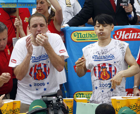 Joey Chestnut reacts after winning the Nathan's annual hot dog eating contest in the Coney Island section of New York, July 4, 2009. Chestnut set a world record by eating 68 hot dogs in 10 minutes.[Xinhua/Reuters] 