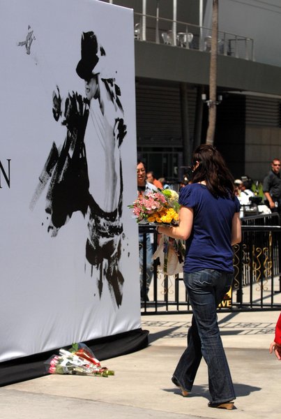 Preparations are being made for Michael Jackson's memorial at the Staples Center in downtown Los Angeles. Posters with a silhouette of Jackson have been put up around the building with the words 'Michael Jackson August 29, 1958 - June 25, 2009'. Flowers were left by two fans outside the center. 