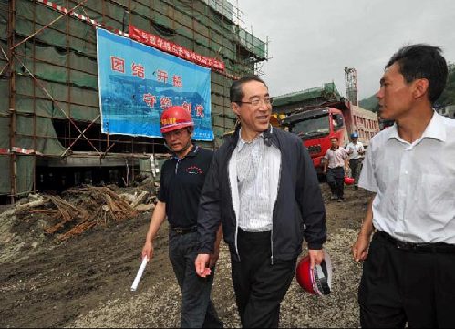 Hong Kong Chief Secretary Henry Tang, left, is briefed on the re-construction progress of the Shuimo Secondary School in Wenchuan, in Sichuan Province on July 5th, 2009. [Photo courtesy of the Hong Kong SAR Government]