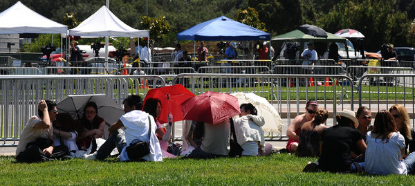 Fans are awaiting the memorial service of Michael Jackson in front of Forest Lawn mortuary. It was officially announced that the memorial services for Michael Jackson would be held there on Tuesday July 7, 2009 at 8:00 am. Jackson died at age 50 when he suffered a cardiac arrest on June 25, 2009 at his Los Angeles home and paramedics were unable to revive him.