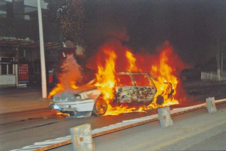 File photo released by the government of Urumqi City in a press conference in Urumqi, capital of northwest China's Xinjiang Uygur Autonomous Region, shows a burnt car in the riot happened on July 5, 2009.[Xinhua]