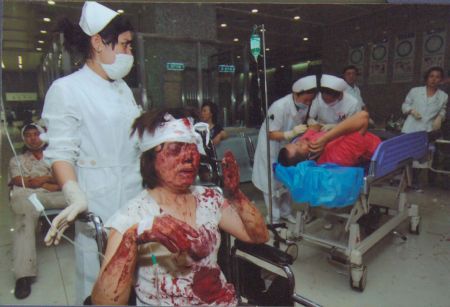 File photo released by the government of Urumqi City in a press conference in Urumqi, capital of northwest China's Xinjiang Uygur Autonomous Region, on July 7, 2009, shows medical workers take care of people injured in the riot happened on July 5, 2009.[Xinhua]