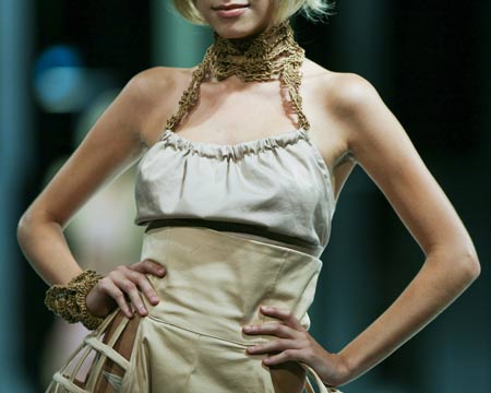 A model presents a creation by student from School of Continuing and Professional Studies of the Chinese University of Hong Kong (CUHKSCS) during a fashion show of Hong Kong Fashion Week for Spring/Summer 2010 in Hong Kong, south China, July 7, 2009. (Xinhua/Zhou Lei)