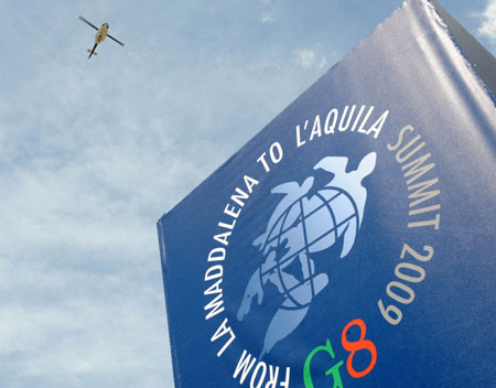 A helicopter is seen flying above the makeshift media village for 2009 G8 summit in L'Aquila, Italy, July 7, 2009. Media personnel from across the world began to swarm into the media village in L'Aquila, the quake-stricken capital of central Italy's Abruzzo region where 2009 G8 summit and other related international meetings will be held from July 8 to 10. (Xinhua/Zeng Yi)