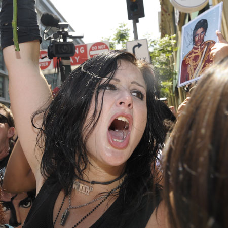 A fan cries out Michael Jackson's name outside the Staples Center in Los Angeles on July 7, 2009. A star-studded public tribute to Michael Jackson was held here Tuesday with thousands of randomly selected fans joining family and friends to bid farewell to the King of Pop.