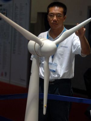 A visitor looks at the model of a generator on display during the 6th Asian Wind Energy Exhibition in Beijing, capital of China, on July 8, 2009. The exhibition, attended by 445 enterprises from 22 countries and regions, kicked off here Wednesday. [Gong Lei/Xinhua]