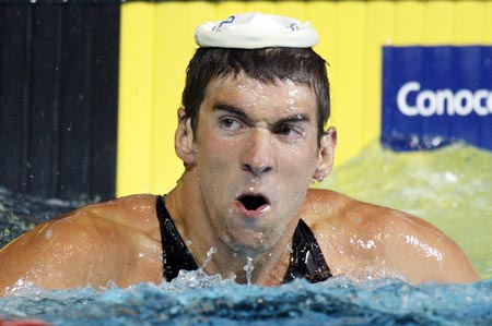 U.S. swimmer Michael Phelps looks to the stands after setting a new world record in the Men's 100m Butterfly at the USA Swimming National Championships in Indianapolis, Indiana, July 9, 2009. (Xinhua/Reuters Photo) 
