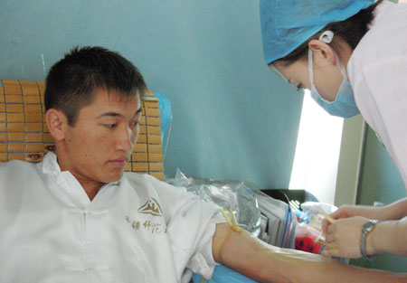 A citizen donates blood for the wounded of the July 5 riot in Urumqi, capital of northwest China's Xinjiang Uygur Autonomous Region, July 10, 2009. [He Jun/Xinhua] 