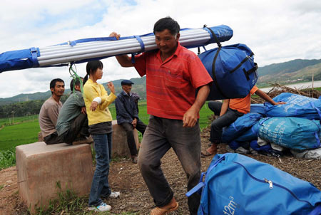 Local villagers set up temporary tents in the earthquake-hit Yao'an County, southwest China's Yunnan Province, July 10, 2009. [Xinhua]