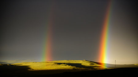 Rainbows emerge at sunset on the grassland of Qiangtang, southwest China's Tibet Autonomous Region, July 11, 2009.[Yang Guang/Xinhua] 