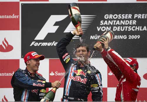 German Grand Prix winner Mark Webber (center) of Red Bull, teammate Sebastian Vettel (back) and Ferrari's Felipe Massa celebrate with champagne on the podium after the race in Nuerburgring yesterday.