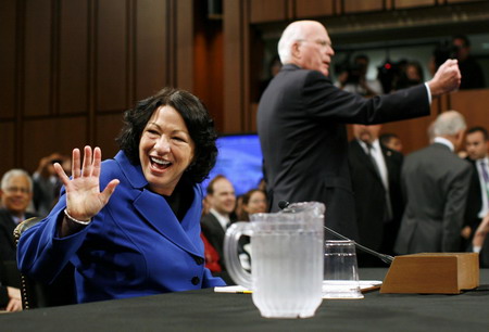 US Supreme Court nominee Judge Sonia Sotomayor (L) takes her seat for her US Senate Judiciary Committee confirmation hearings, accompanied by Judiciary Committee Chairman Senator Patrick Leahy (D-VT), on Capitol Hill in Washington July 13, 2009. [China Daily/Agencies]